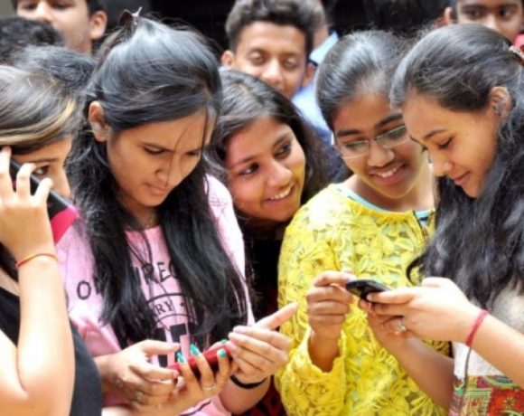 Students checking their results on mobile phones