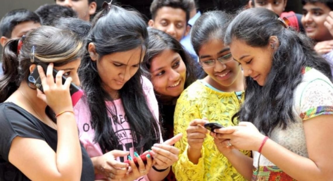 Students checking their results on mobile phones