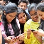 Students checking their results on mobile phones